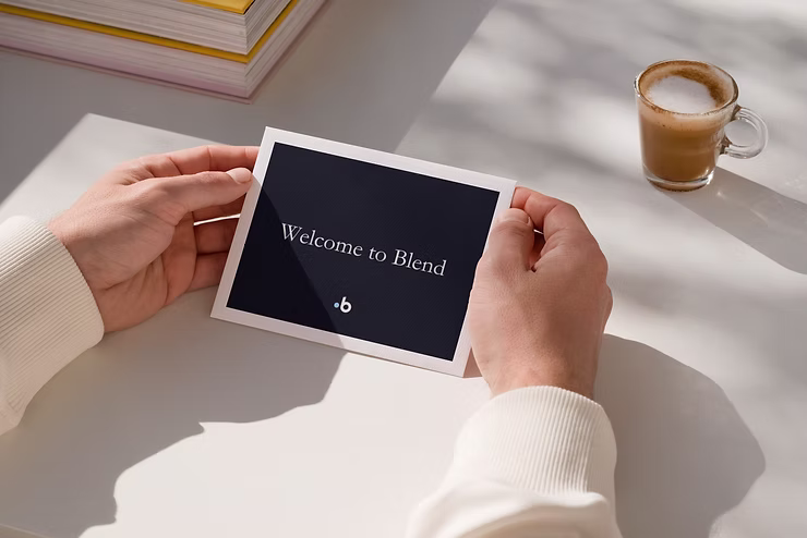 A 'Welcome to Blend' envelope is held in someone's hands.