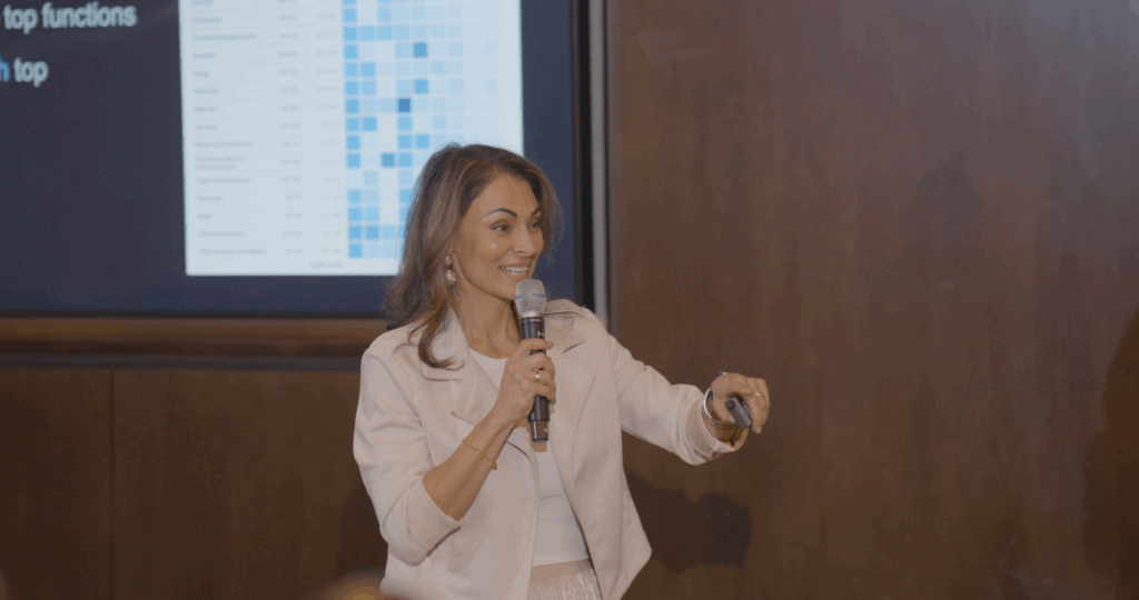 Sol Rashidi - the world's first Chief AI Officer - delivers a panel talk. She speaks into a microphone while smiling.