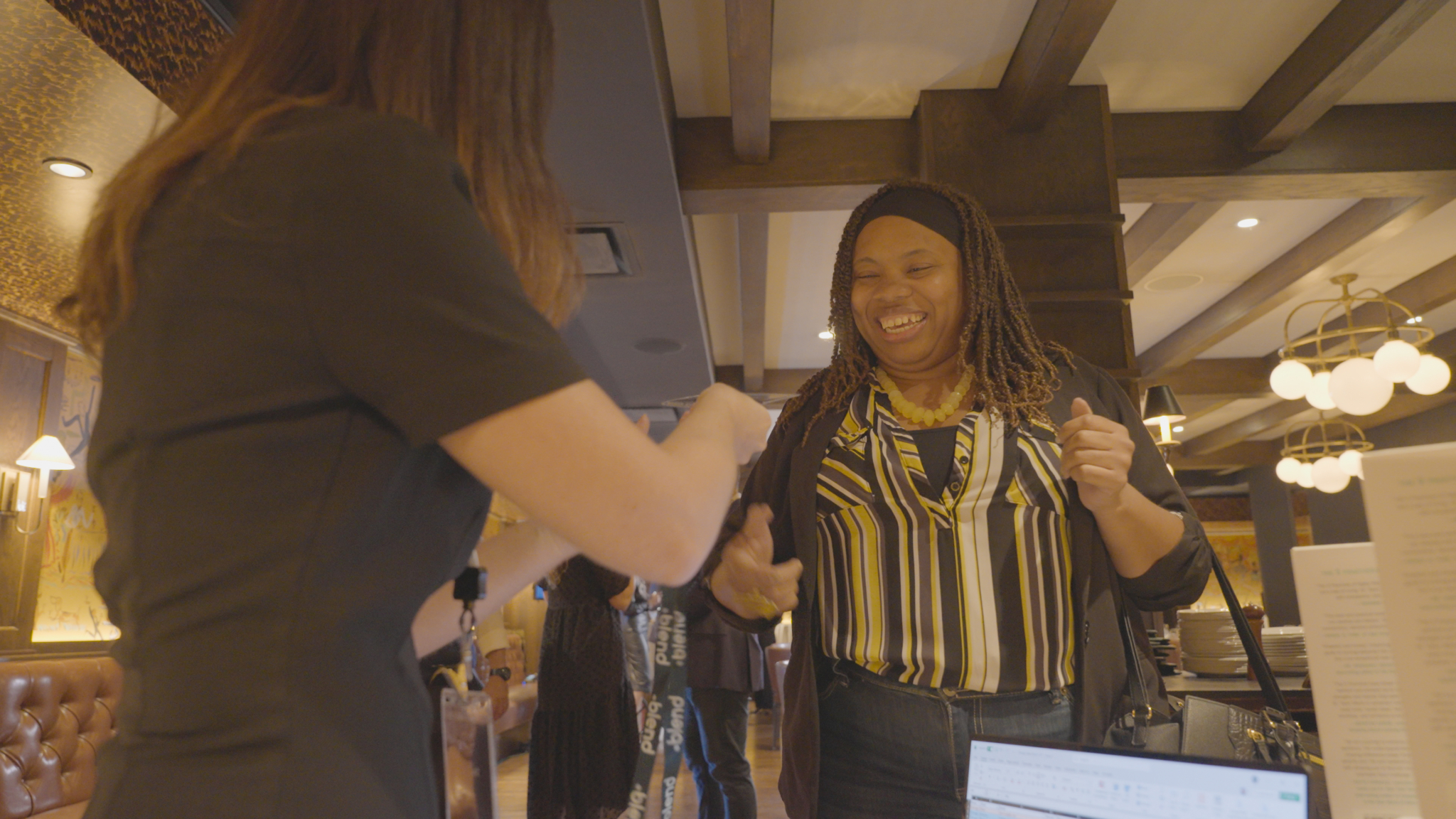 A C-Suite attendee arrives and is greeted warmly at a Blend community networking event.