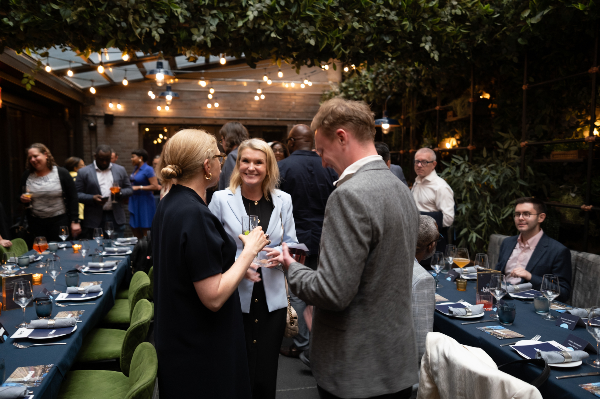A group of C-suite professionals talk at a Blend community networking event.