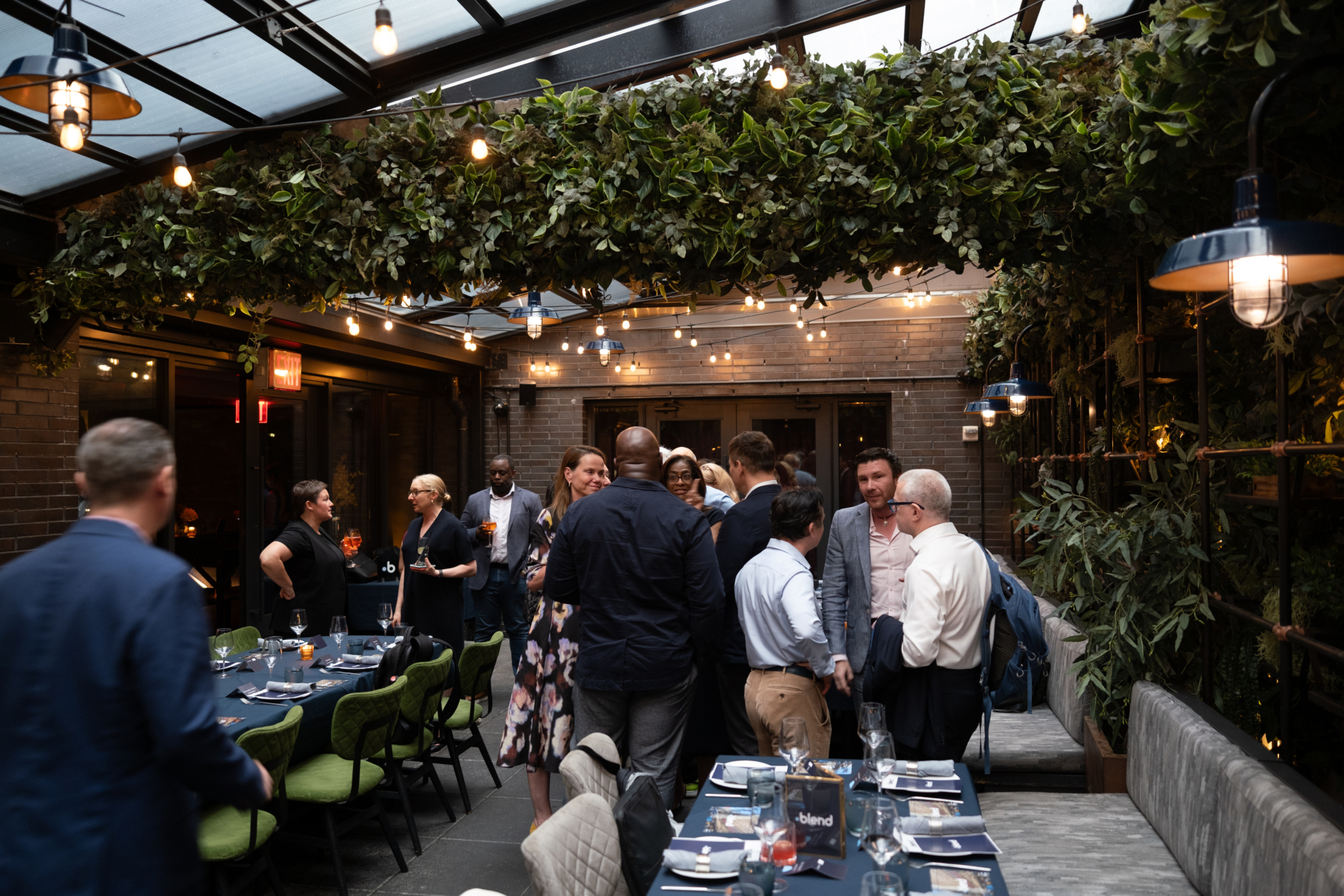 A group of C-suite professionals talk at a Blend community networking event.