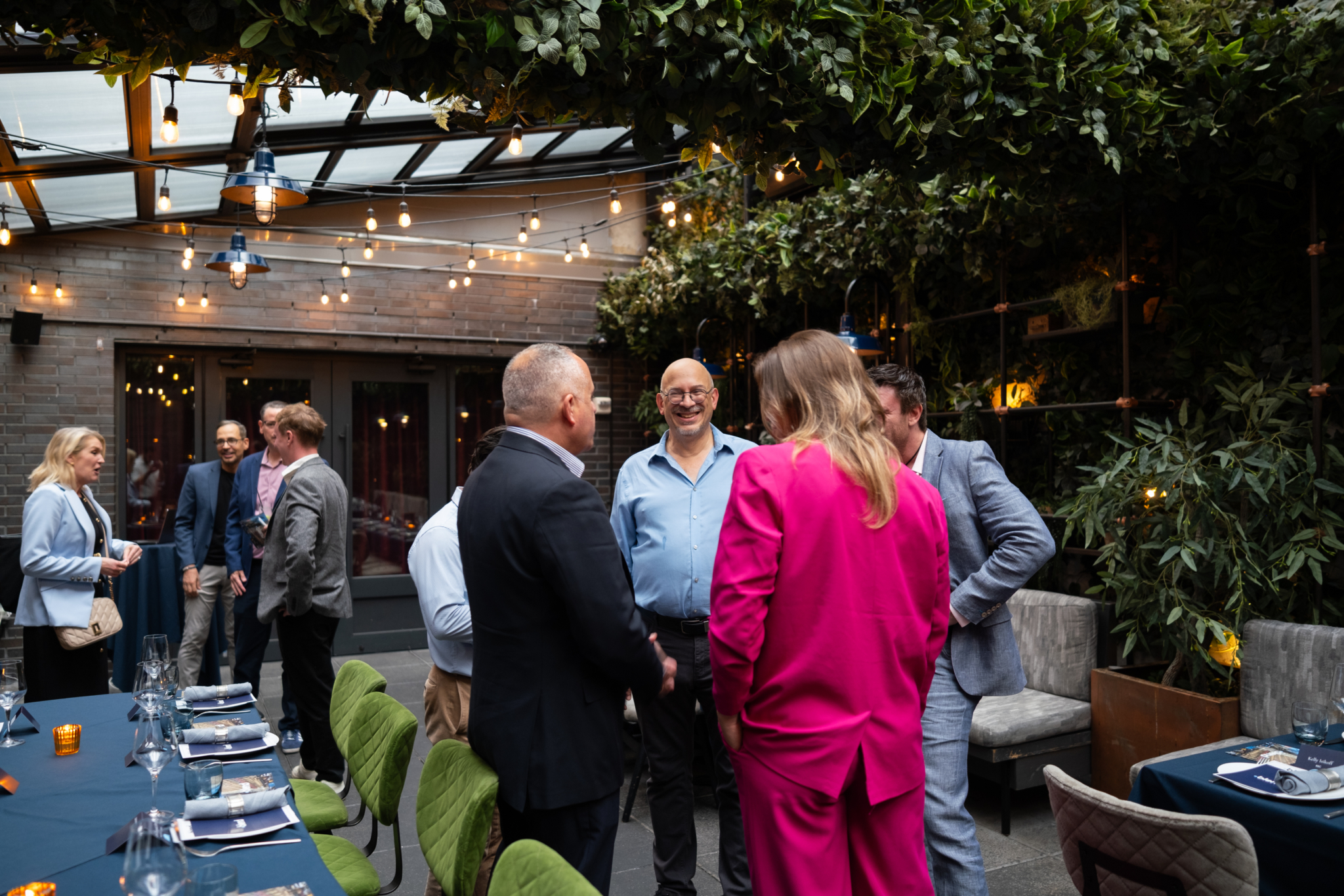 A group of C-suite professionals talk at a Blend community networking event.