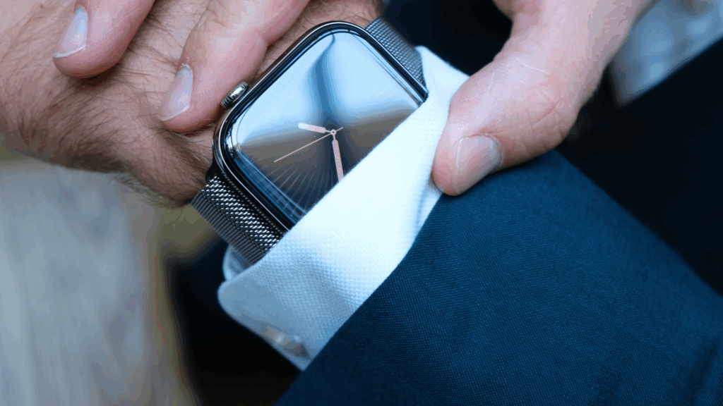 A digital watch on a wrist that reads "1.50pm" peeps out of shirt cuff.