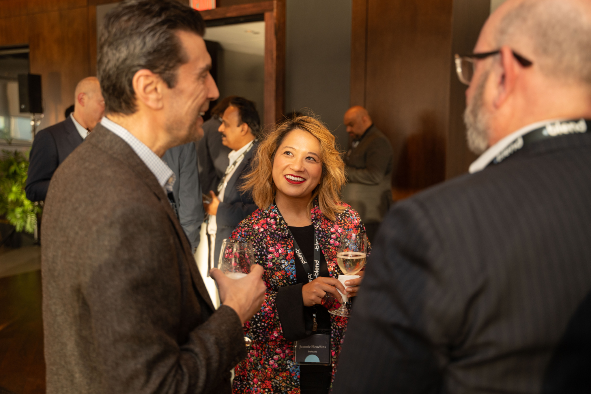 A group of C-suite professionals talk at a Blend community networking event.