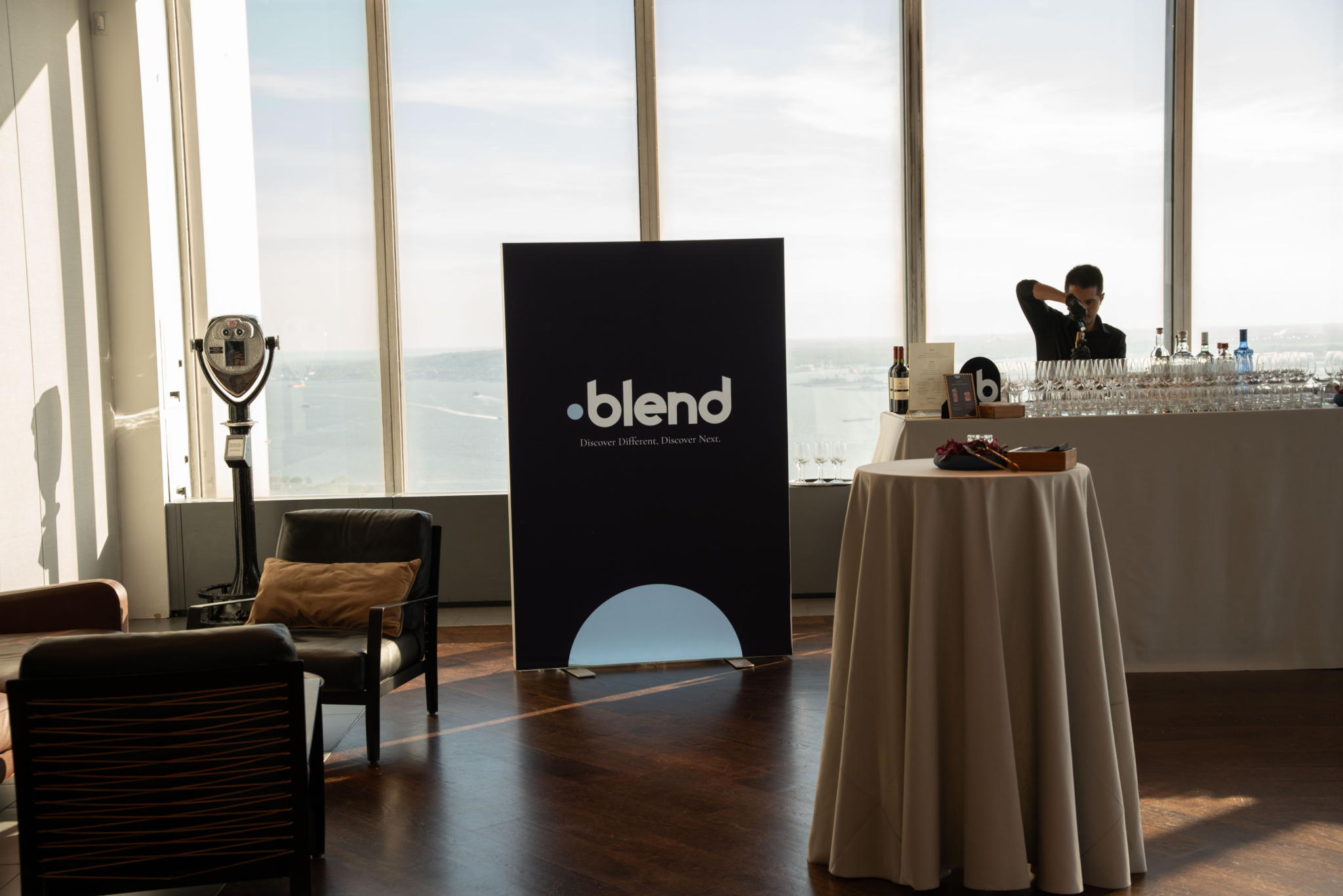 Sponsorship for events: Blend's logo on an a-board at an event, next to a tended-to bar.