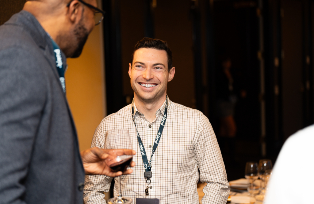 Two C-suite professionals enjoy a conversation at a Blend community networking event.